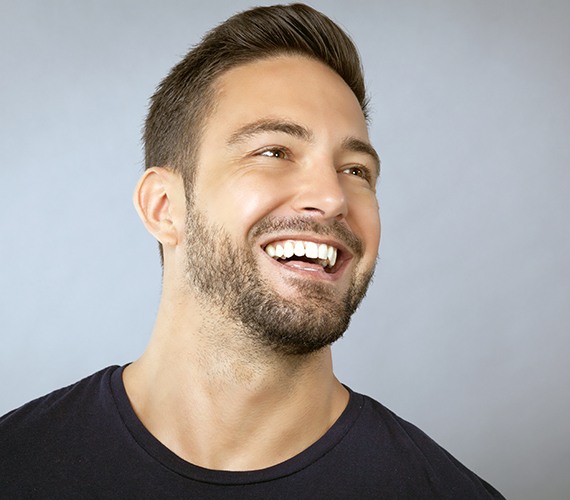 Man's smile after metal free dental restoration