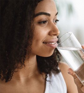 woman drinking water as part of a nutritious diet