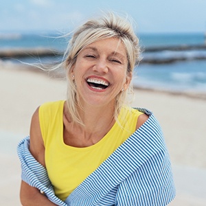 smiling woman who is a good candidate for implants