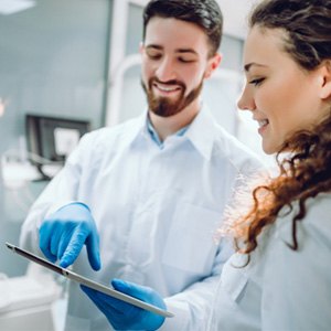 a dentist explaining the cost of cosmetic dentistry to patient