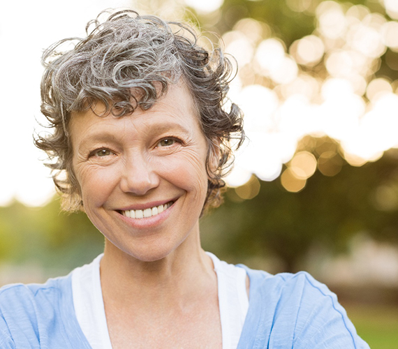 woman outside smiling with dentures