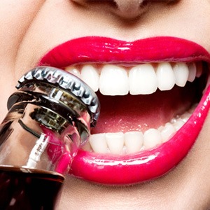 woman who shouldn’t be opening a bottle with her teeth