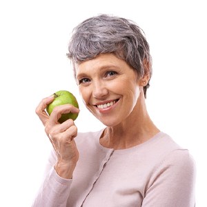 woman holding a green apple