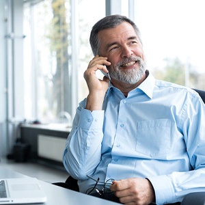 businessman sitting at his desk and talking on the phone