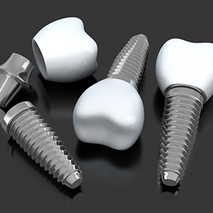 three dental implants with abutments and crowns lying on a flat surface 