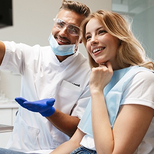 dentist showing a patient their X-rays 