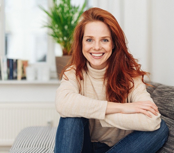 Happy woman smiling after recovering from dental implant surgery