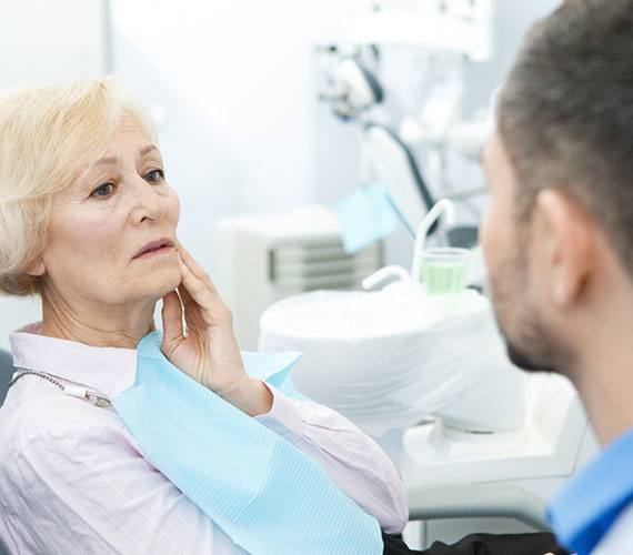 Woman with a failed dental implant in Fort Worth