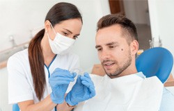 Dental assistant showing patient clear aligner