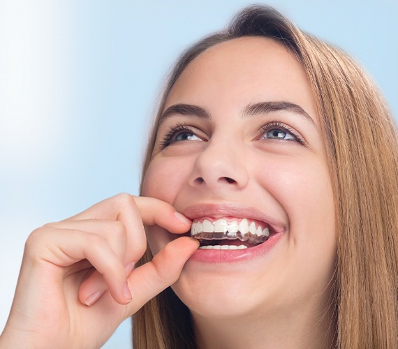 Woman placing an Invisalign tray