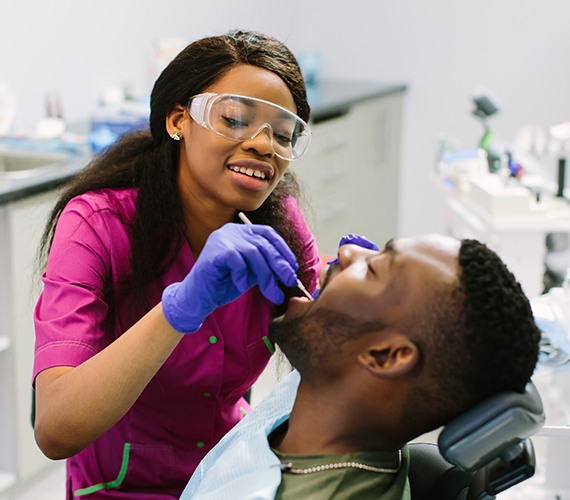 Man receiving oral cancer screening