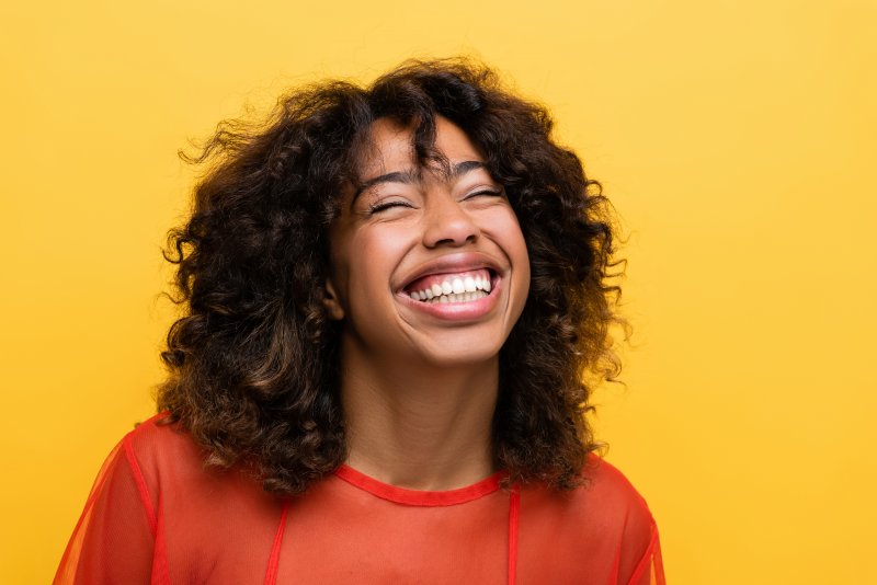 woman enjoying the benefits of implant dentures in Fort Worth