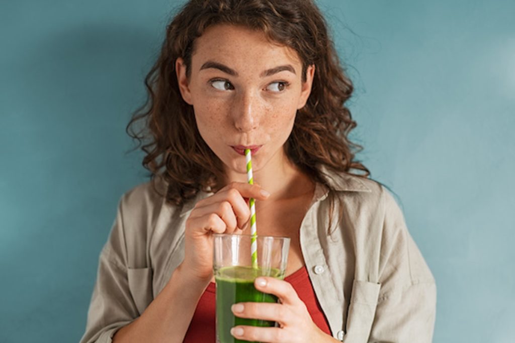 person drinking through a straw