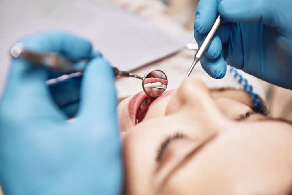 Woman having mouth examined by dentist