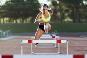 Runner jumping a hurdle.